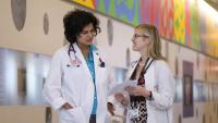 two doctors talking in a hallway